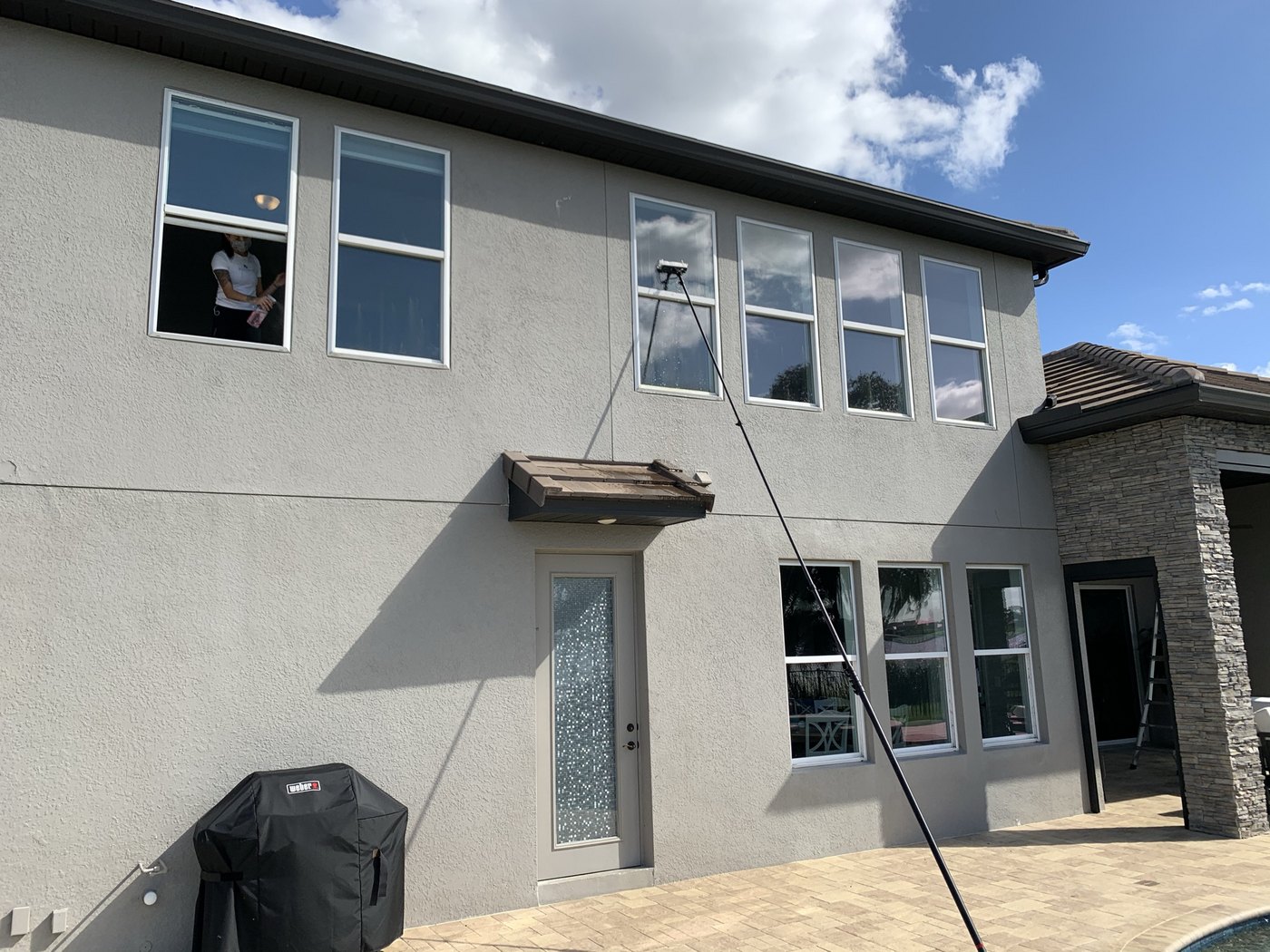 Second story windows cleaned by pole